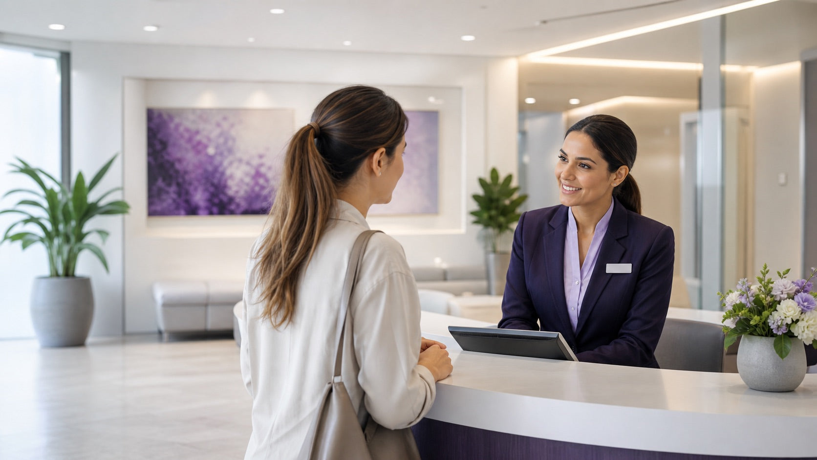 A front desk host checking in a visitor