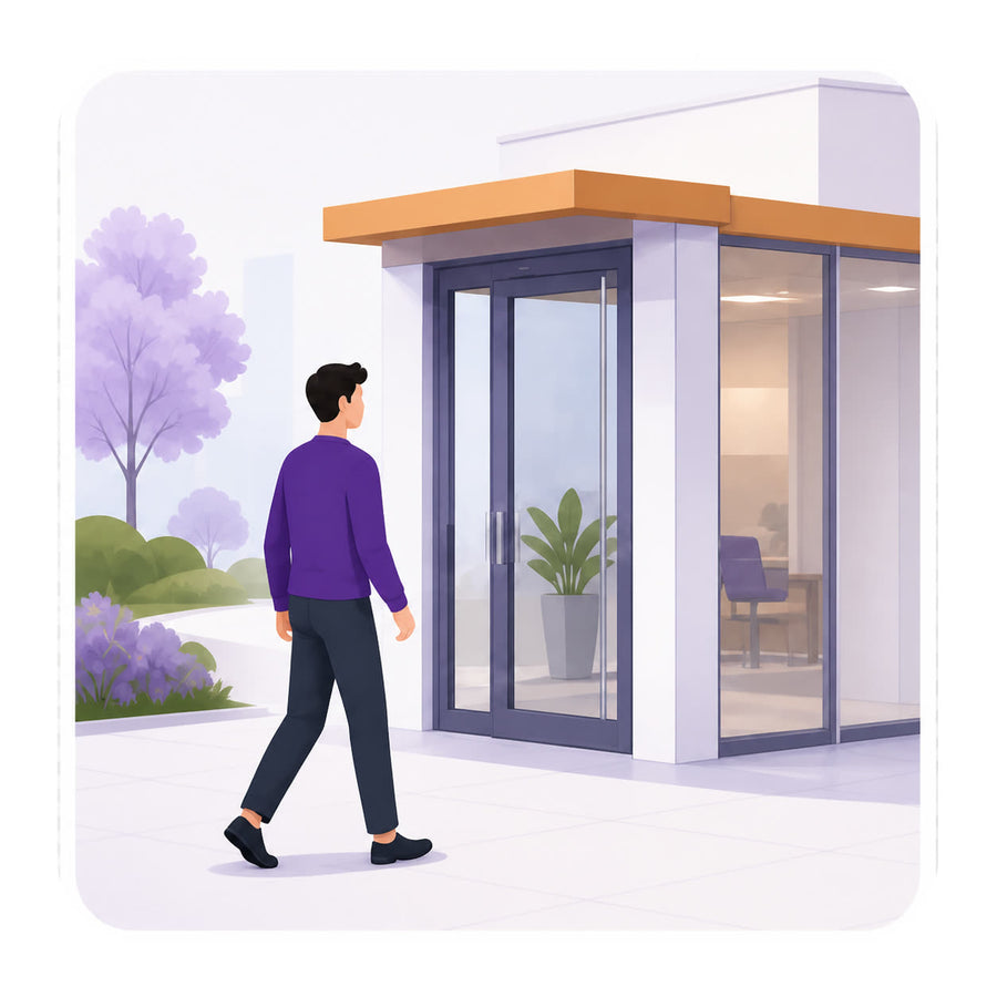 A visitor walking up to the building entrance